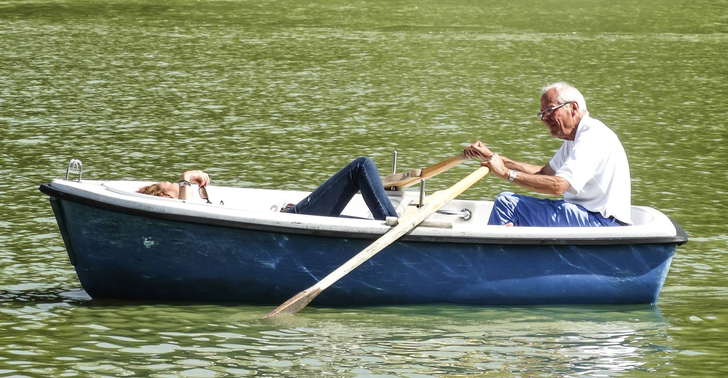 Un retraité ramant dans une barque sur un lac